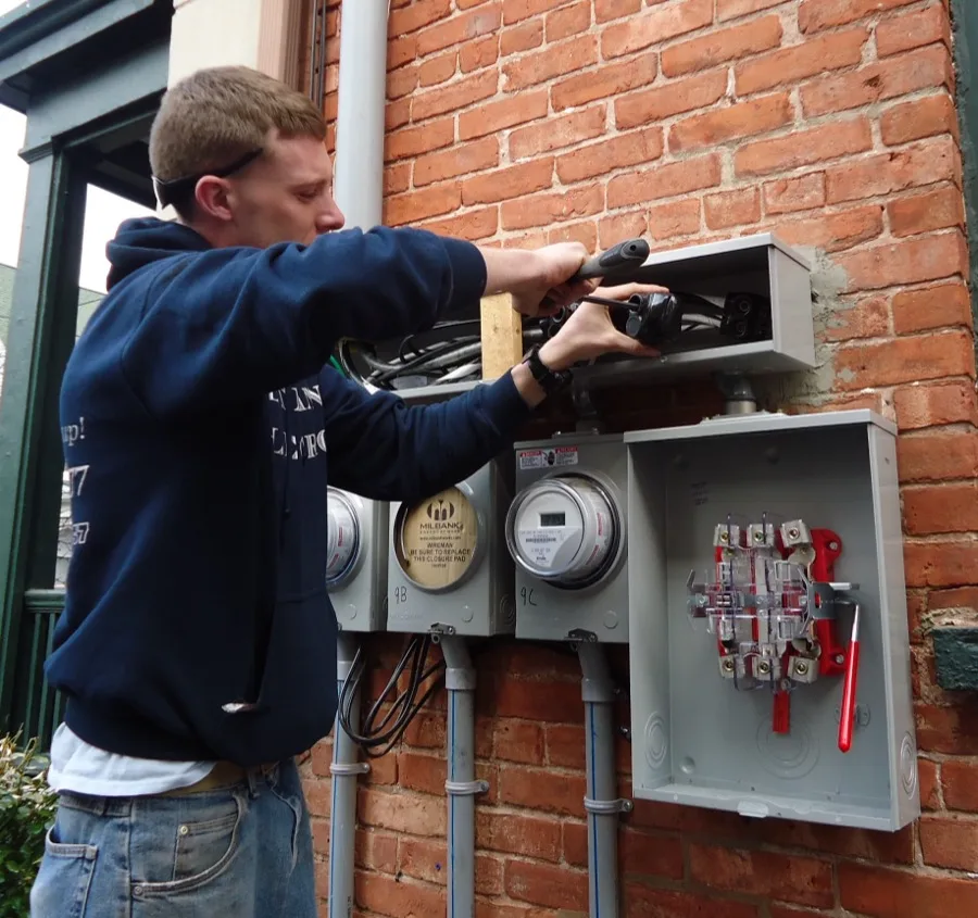 Electrician installing residential meter panel connections